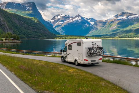 autocaravana en la carretera frente a un lago